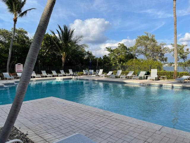 1200 Scotia Drive, Unit 305 Hypoluxo, FL 33462 - Photo 17 of 28 a view of a swimming pool with a lake view