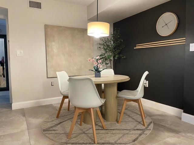 1200 Scotia Drive, Unit 305 Hypoluxo, FL 33462 - Photo 2 of 28 a dining room with a table and chairs