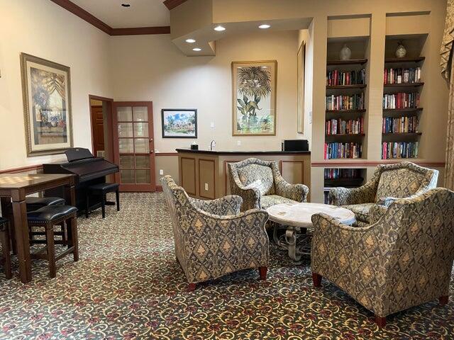 1200 Scotia Drive, Unit 305 Hypoluxo, FL 33462 - Photo 24 of 28 a living room with furniture a window and bookshelf