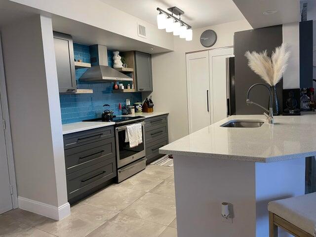 1200 Scotia Drive, Unit 305 Hypoluxo, FL 33462 - Photo 4 of 28 a kitchen with stainless steel appliances kitchen island granite countertop a sink a stove and cabinets