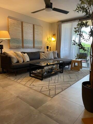 1200 Scotia Drive, Unit 305 Hypoluxo, FL 33462 - Photo 7 of 28 a living room with furniture and a large window