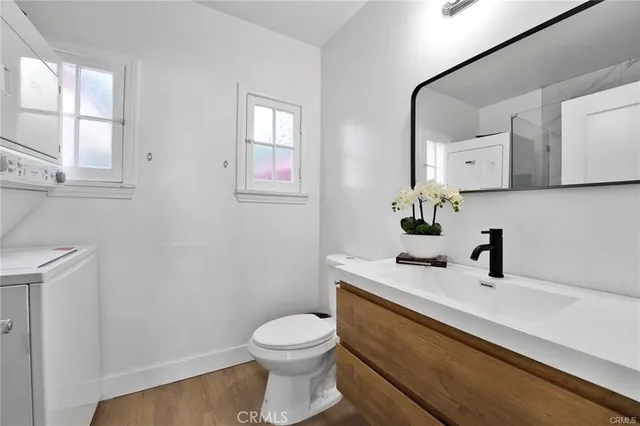 a bathroom with a sink a toilet and mirror