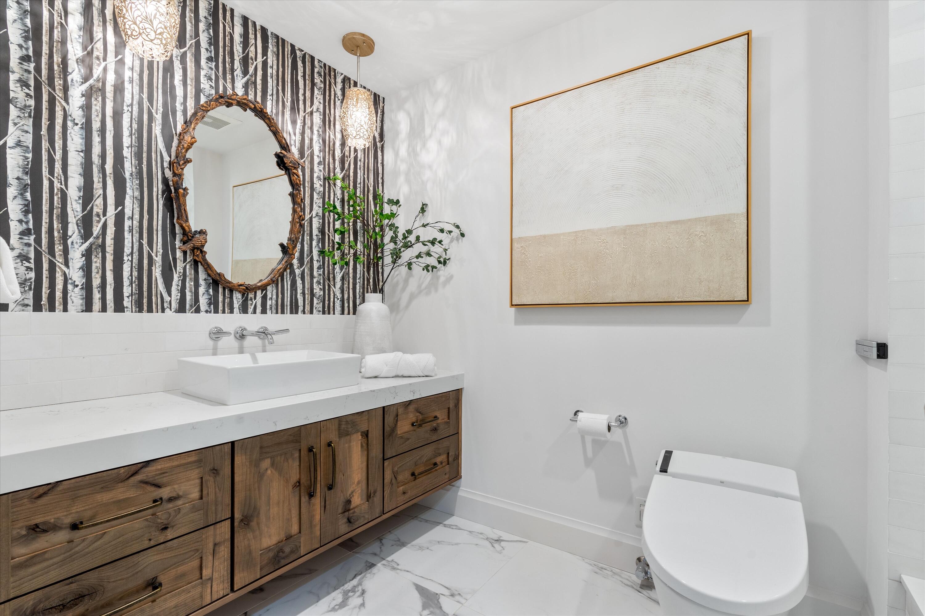 500 Southeast Mizner Boulevard, Unit A202 Boca Raton, FL 33432 - Photo 18 of 37 a bathroom with a toilet a sink and a mirror