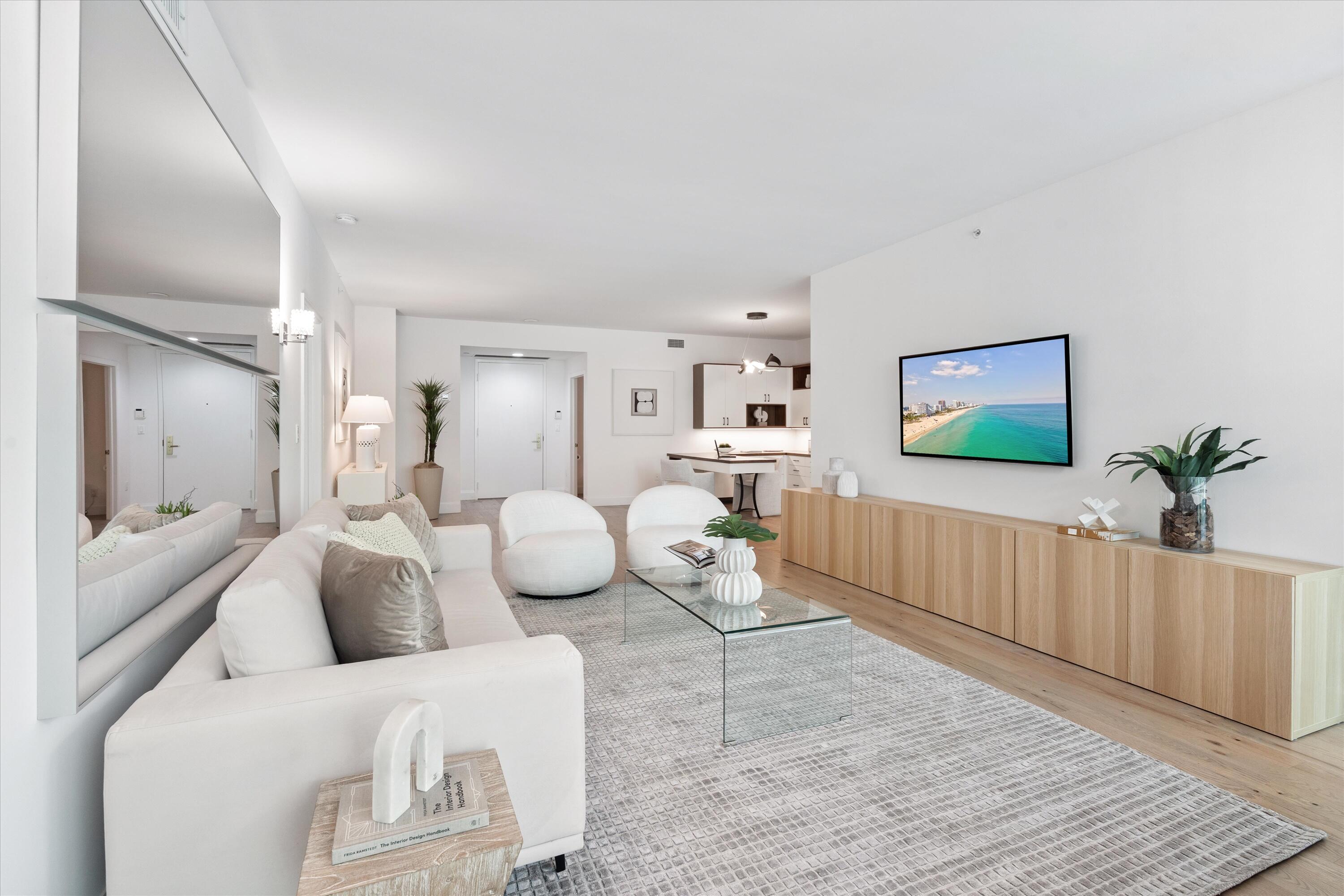 500 Southeast Mizner Boulevard, Unit A202 Boca Raton, FL 33432 - Photo 4 of 37 a living room with furniture and a flat screen tv