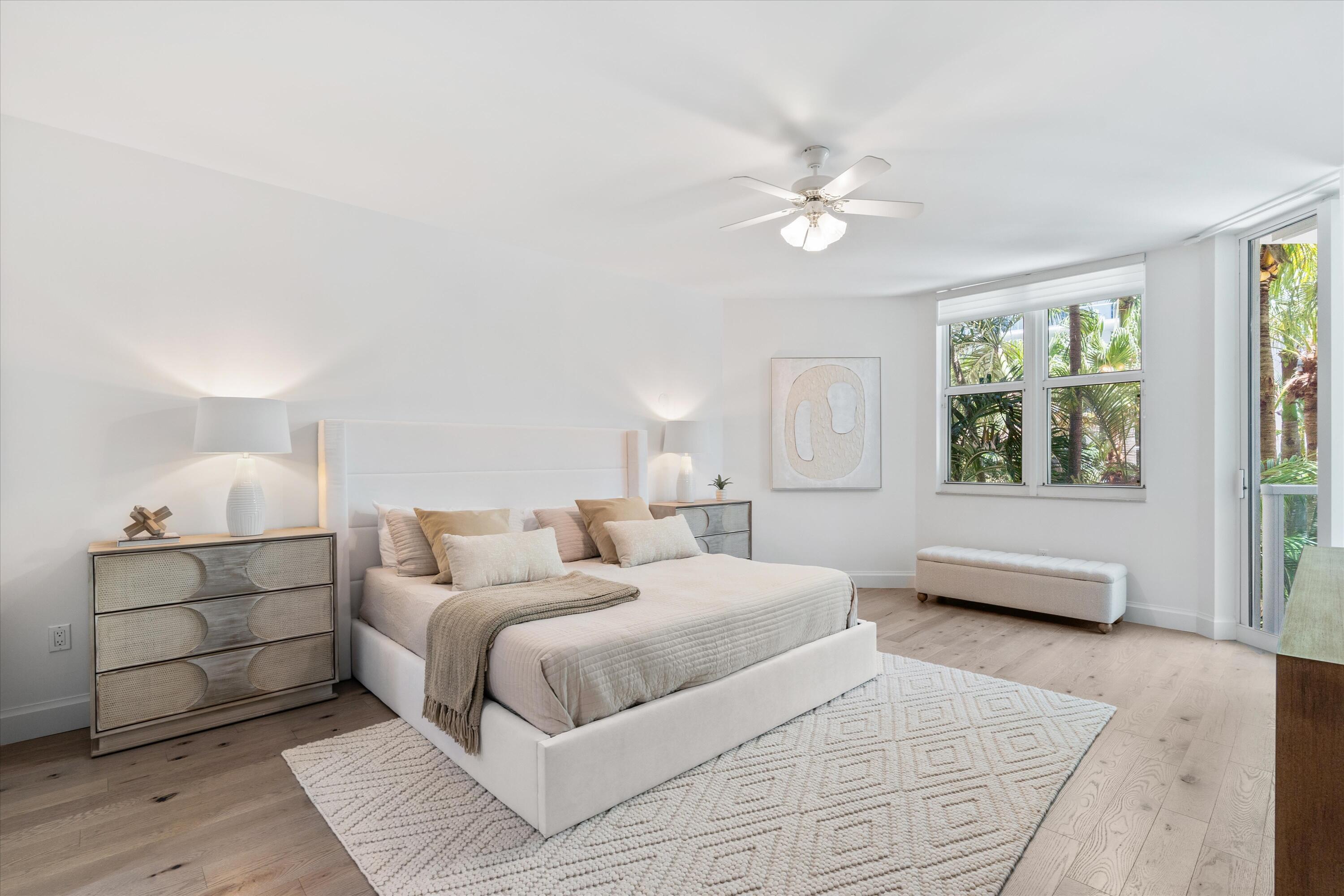 500 Southeast Mizner Boulevard, Unit A202 Boca Raton, FL 33432 - Photo 10 of 37 a bedroom with a large bed and a couch