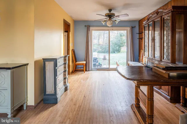 a view of a livingroom with furniture window wooden floor and backyard