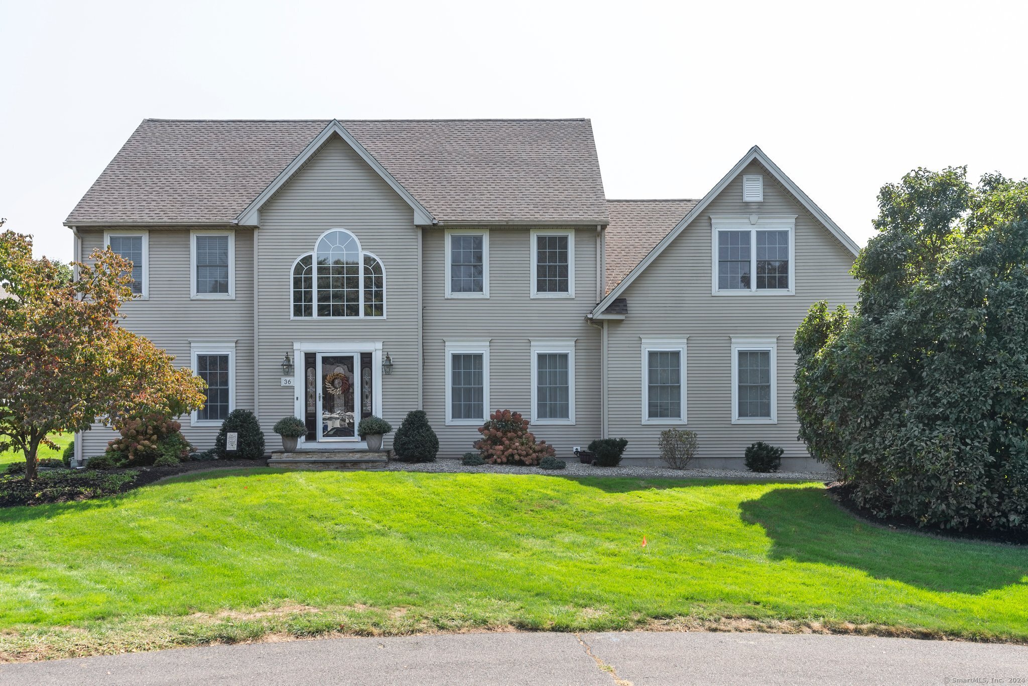 36 St Andrews Glastonbury, CT 06033 - Photo 1 of 1 a front view of a house with a yard and potted plants