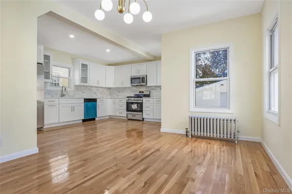 a view of a kitchen with microwave and cabinets