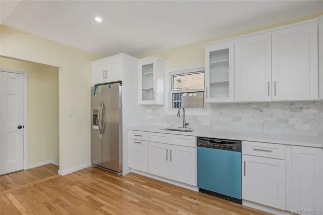 a kitchen with stainless steel appliances granite countertop a refrigerator and a sink