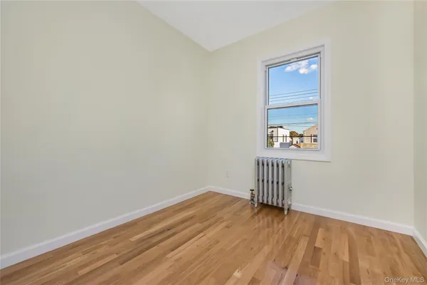 a view of a room with wooden floor