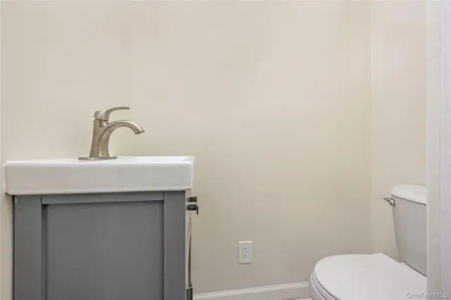 a bathroom with a sink a toilet and mirror