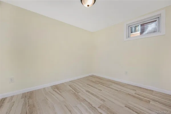 a view of a room with wooden floor and fan