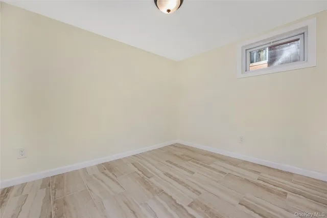 a view of a room with wooden floor and fan