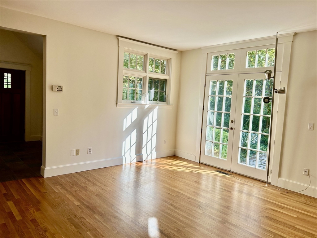 99 Tower Road Lincoln, MA 01773 - Photo 11 of 42 wooden floor in an empty room with a window