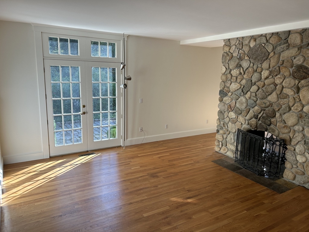 99 Tower Road Lincoln, MA 01773 - Photo 12 of 42 a view of an empty room with wooden floor and a window