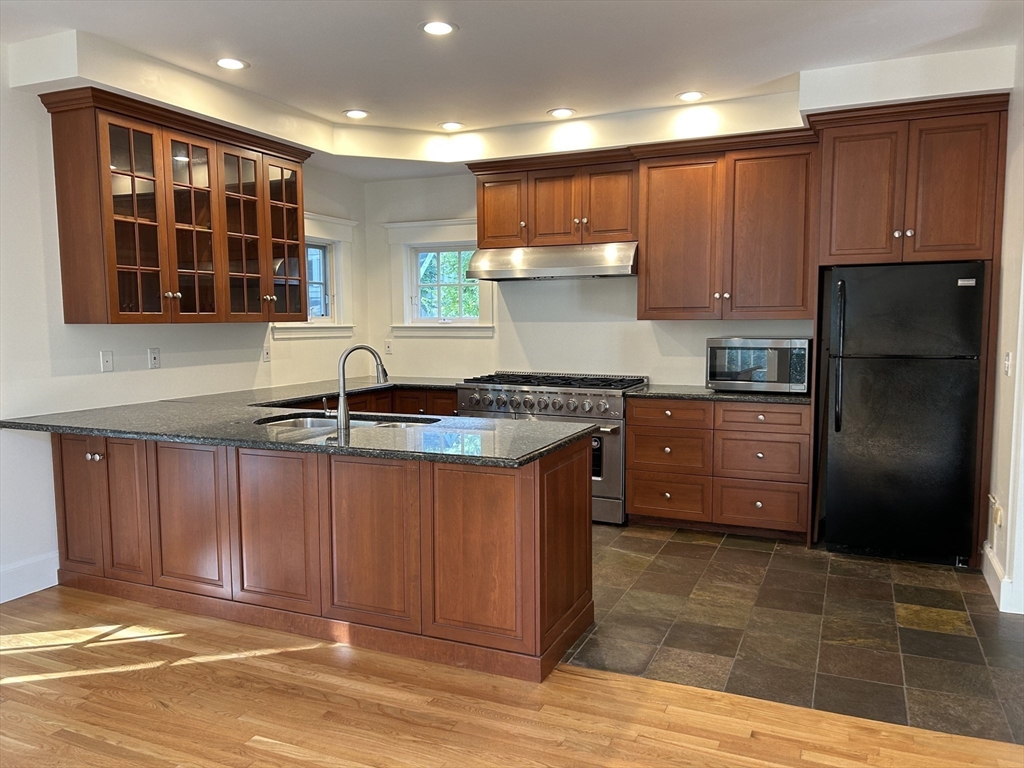99 Tower Road Lincoln, MA 01773 - Photo 15 of 42 a kitchen with stainless steel appliances granite countertop a stove a sink and a refrigerator