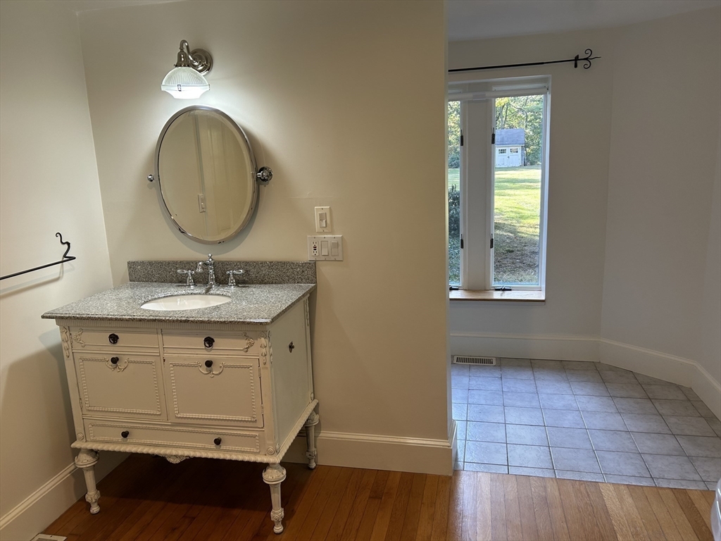99 Tower Road Lincoln, MA 01773 - Photo 21 of 42 a bathroom with a sink mirror vanity and a toilet