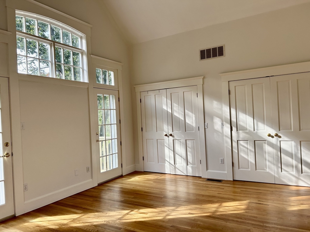 99 Tower Road Lincoln, MA 01773 - Photo 27 of 42 a view of wooden floor and windows in a room
