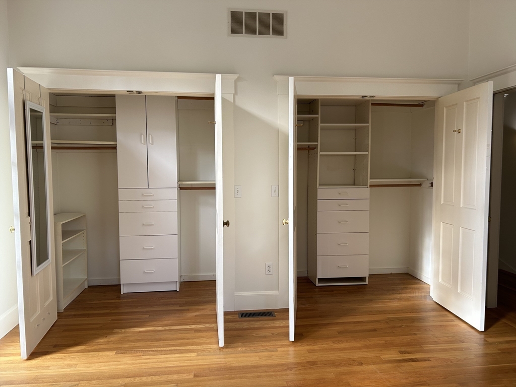 99 Tower Road Lincoln, MA 01773 - Photo 28 of 42 a view of an empty room with wooden floor and closet area