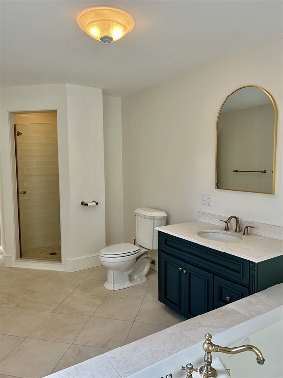 99 Tower Road Lincoln, MA 01773 - Photo 30 of 42 a bathroom with a toilet sink and mirror
