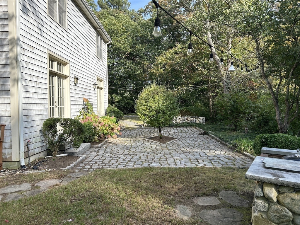99 Tower Road Lincoln, MA 01773 - Photo 37 of 42 a view of a backyard with plants and a patio