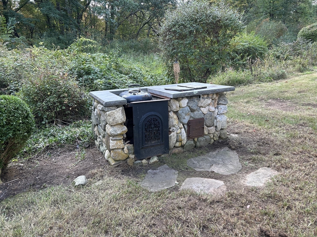 99 Tower Road Lincoln, MA 01773 - Photo 38 of 42 a view of a wooden house with a yard and large trees