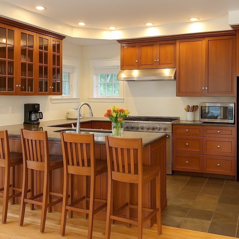 99 Tower Road Lincoln, MA 01773 - Photo 6 of 42 a kitchen with stainless steel appliances a sink and cabinets