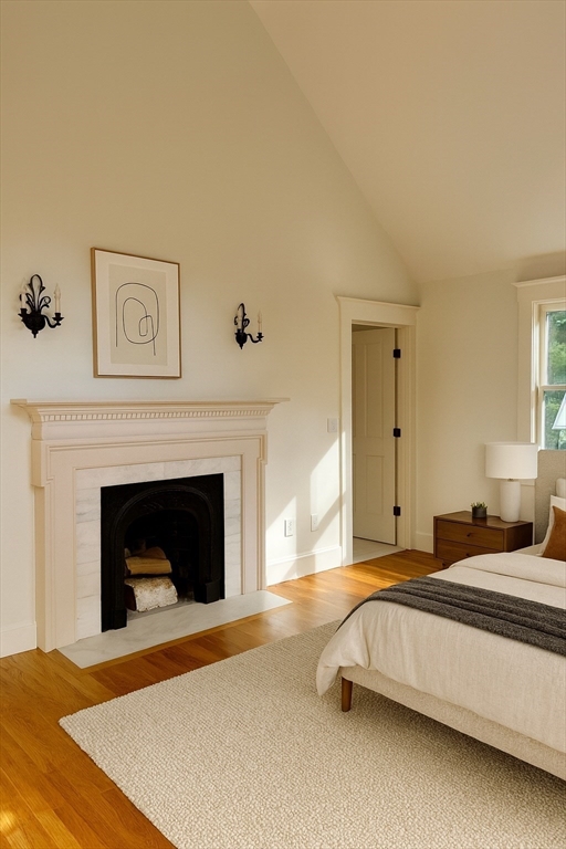 99 Tower Road Lincoln, MA 01773 - Photo 9 of 42 a spacious bedroom with a bed and a fireplace