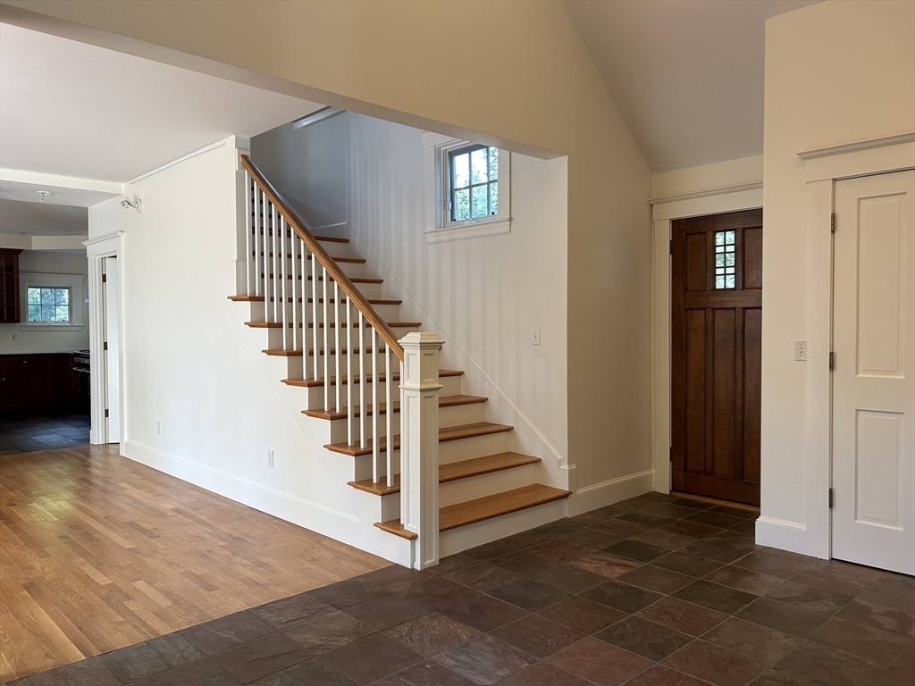 99 Tower Road Lincoln, MA 01773 - Photo 10 of 42 a view of a hallway with staircase with white walls and stairs