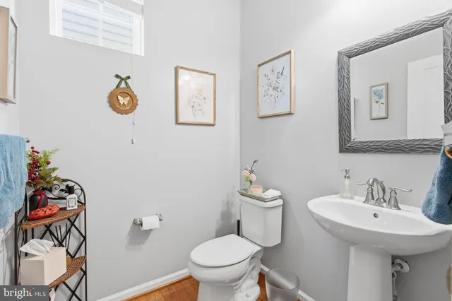 a bathroom with a toilet a sink and mirror