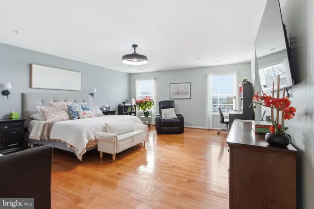 a bedroom with bed or couch and a flat tv screen on a dresser