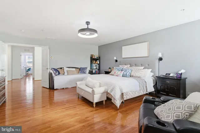 a bedroom with bed and a chair