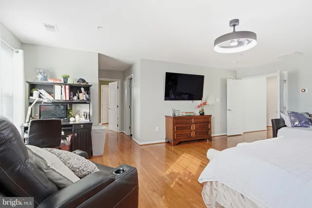 a bedroom with furniture and a flat screen tv