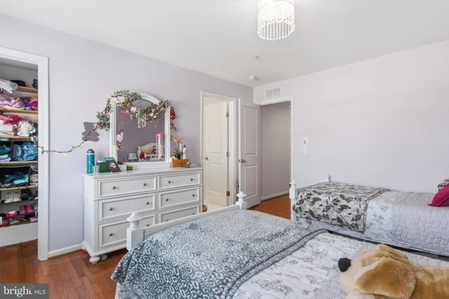a bedroom with furniture and wooden floor