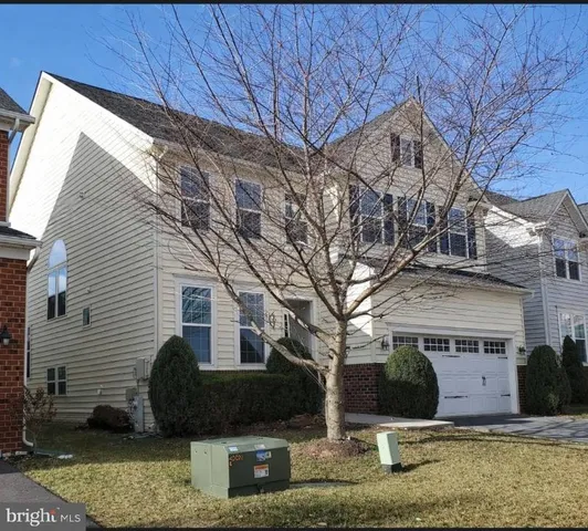 a living room with furniture potted plant and a window