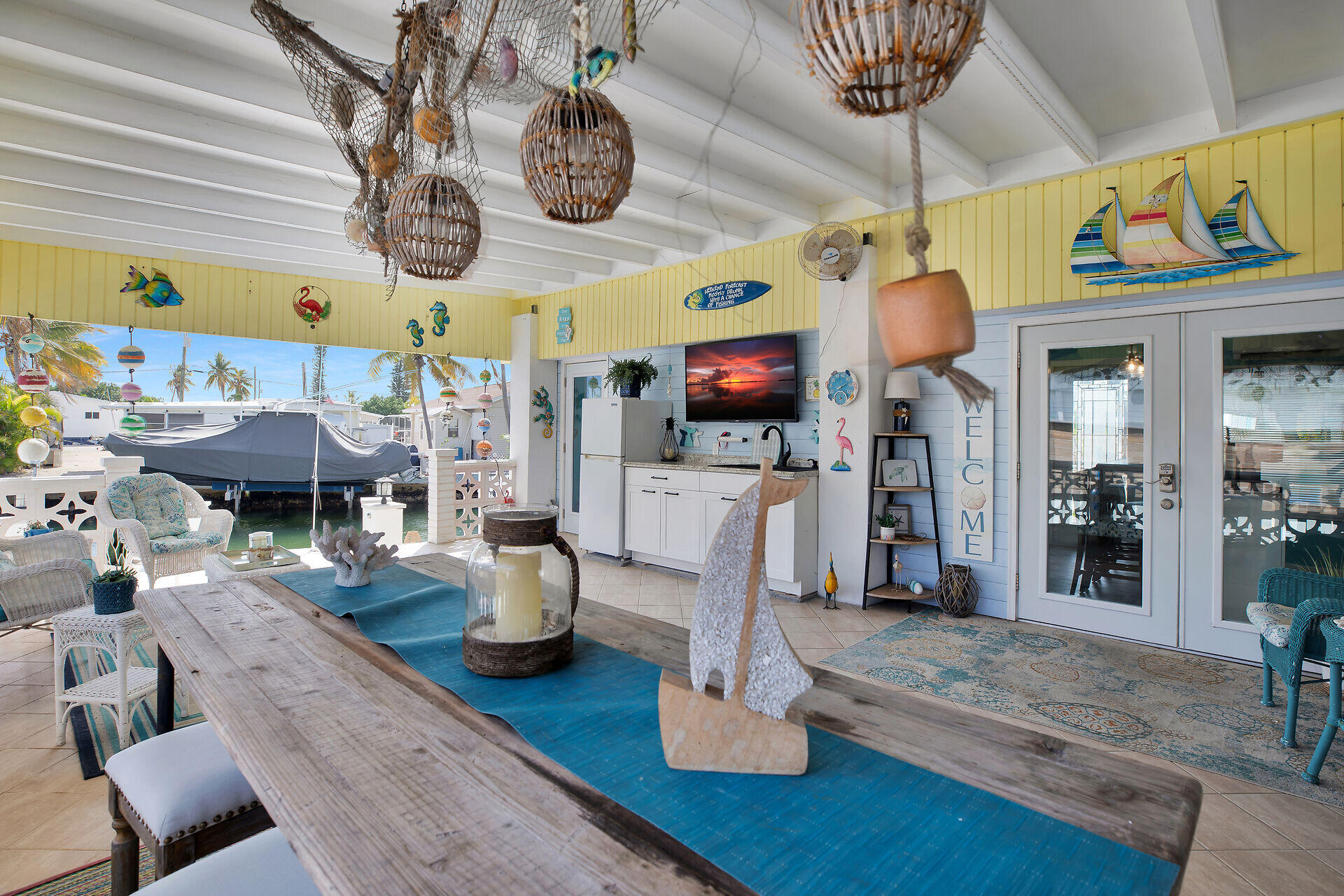 779 26th Street Ocean Marathon, FL 33050 - Photo 19 of 42 a view of a dining room with furniture a chandelier and wooden floor