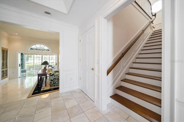 a bedroom with a bed window and a flat tv screen
