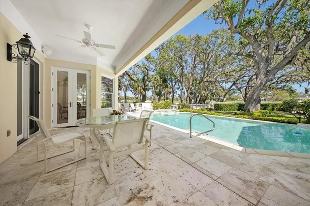 a front view of a house with a garden and tree