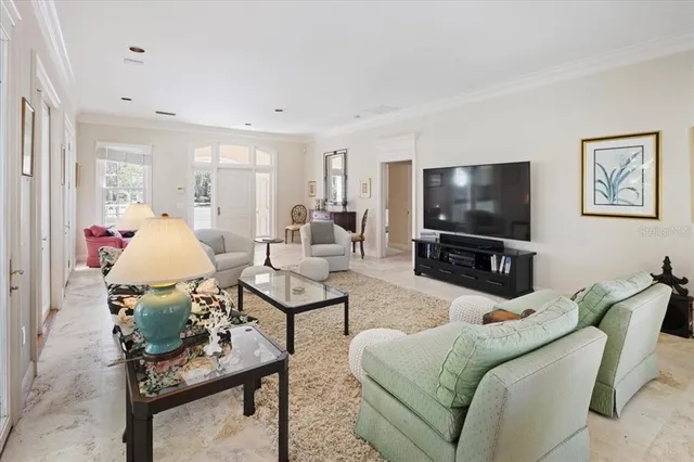 a living room with lots of furniture and a chandelier