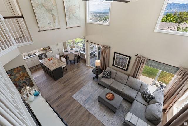 14883 Tooele Lane Draper, UT 84020 - Photo 22 of 49 Open-concept living space featuring high ceilings, wood-finish flooring, and large windows