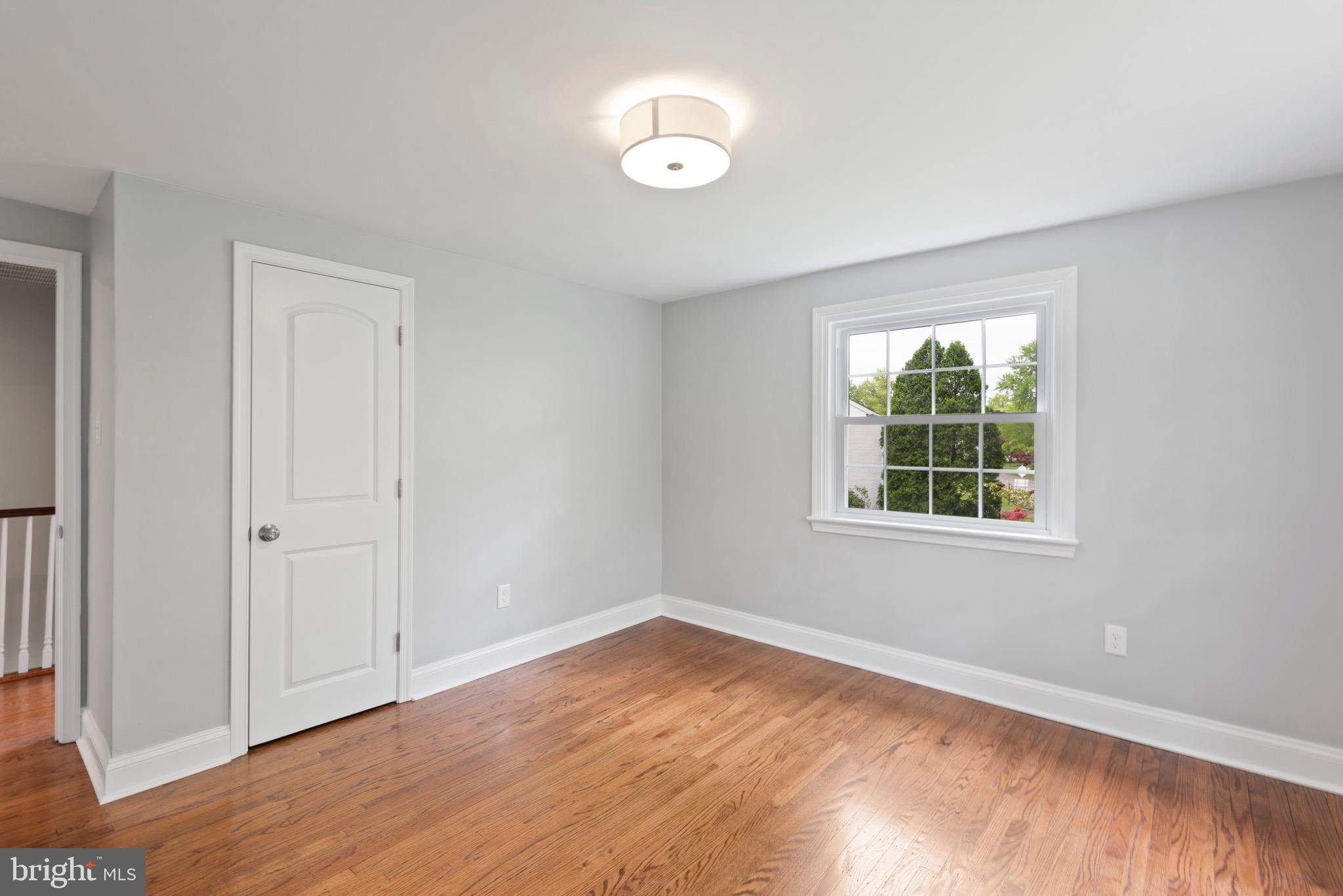103 East Rose Valley Road Wallingford, PA 19086 - Photo 40 of 75 an empty room with wooden floor and windows