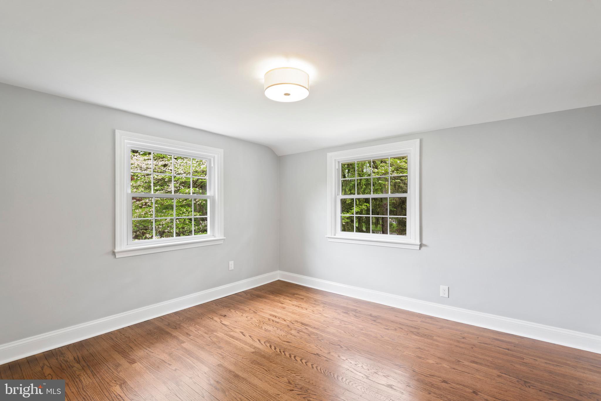 103 East Rose Valley Road Wallingford, PA 19086 - Photo 41 of 75 a view of an empty room with wooden floor and a window