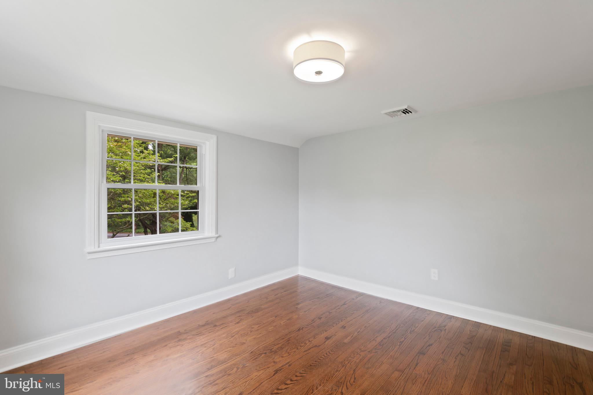 103 East Rose Valley Road Wallingford, PA 19086 - Photo 42 of 75 an empty room with wooden floor and windows