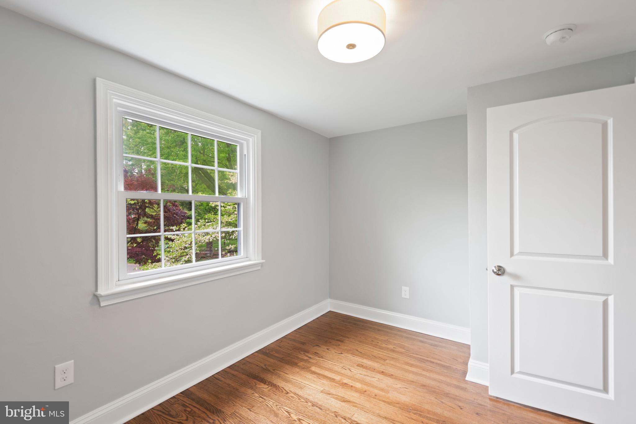 103 East Rose Valley Road Wallingford, PA 19086 - Photo 43 of 75 an empty room with wooden floor and windows