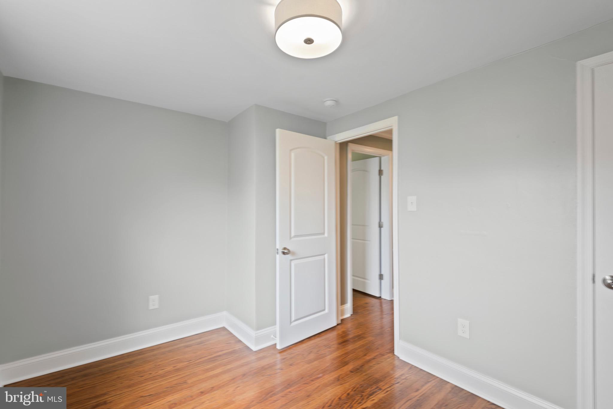 103 East Rose Valley Road Wallingford, PA 19086 - Photo 44 of 75 a view of empty room with wooden floor and fan