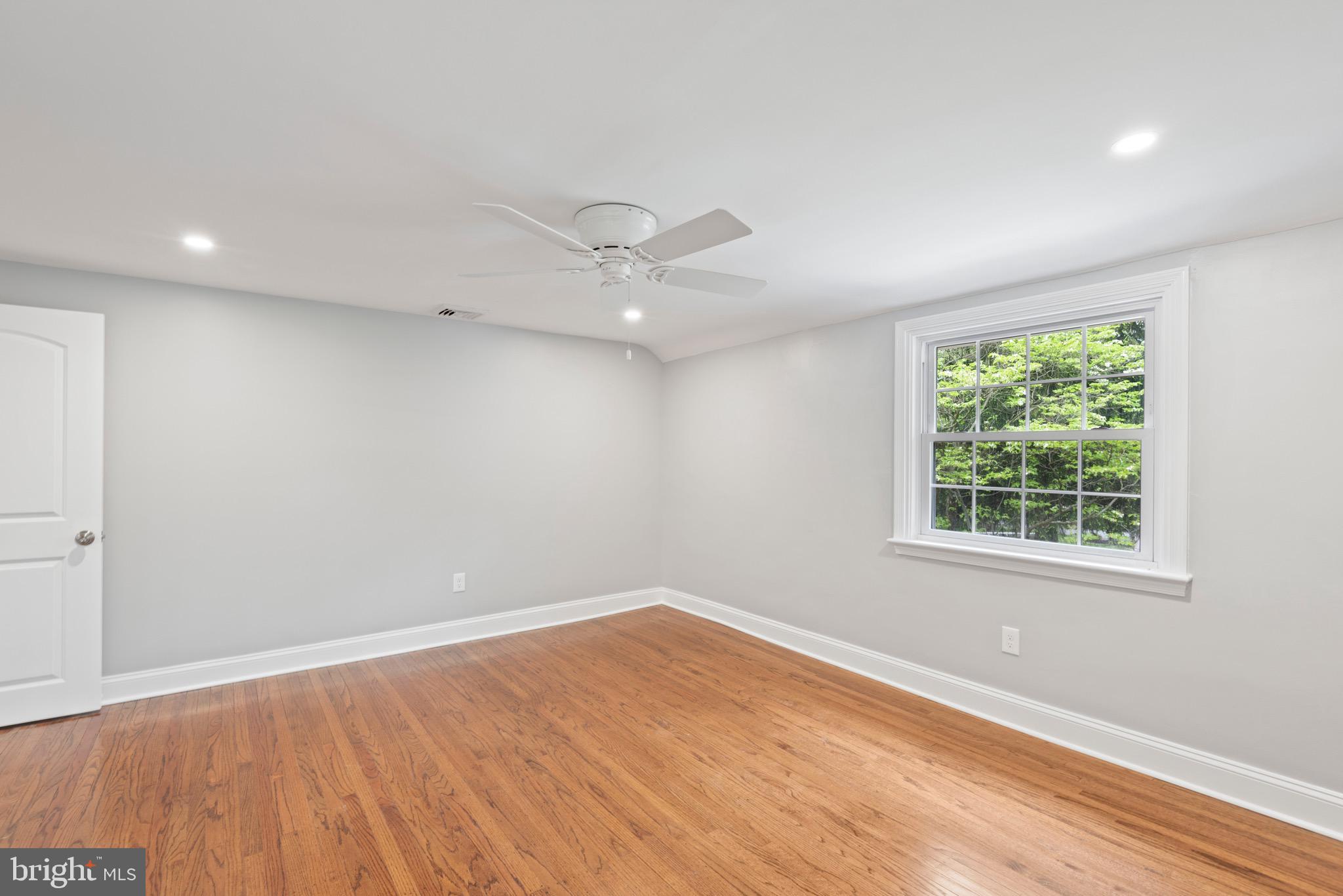 103 East Rose Valley Road Wallingford, PA 19086 - Photo 55 of 75 an empty room with wooden floor and windows