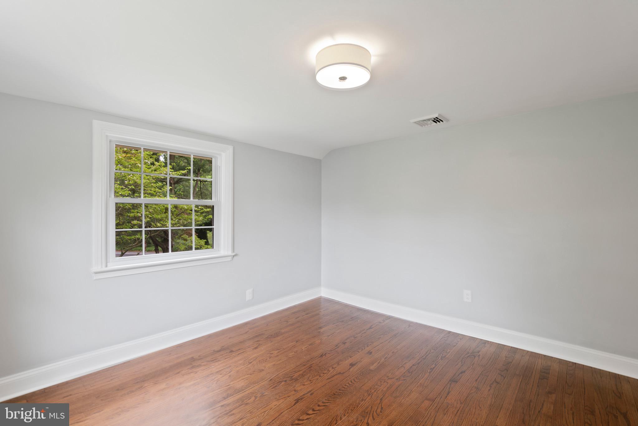 103 East Rose Valley Road Wallingford, PA 19086 - Photo 58 of 75 an empty room with wooden floor and windows