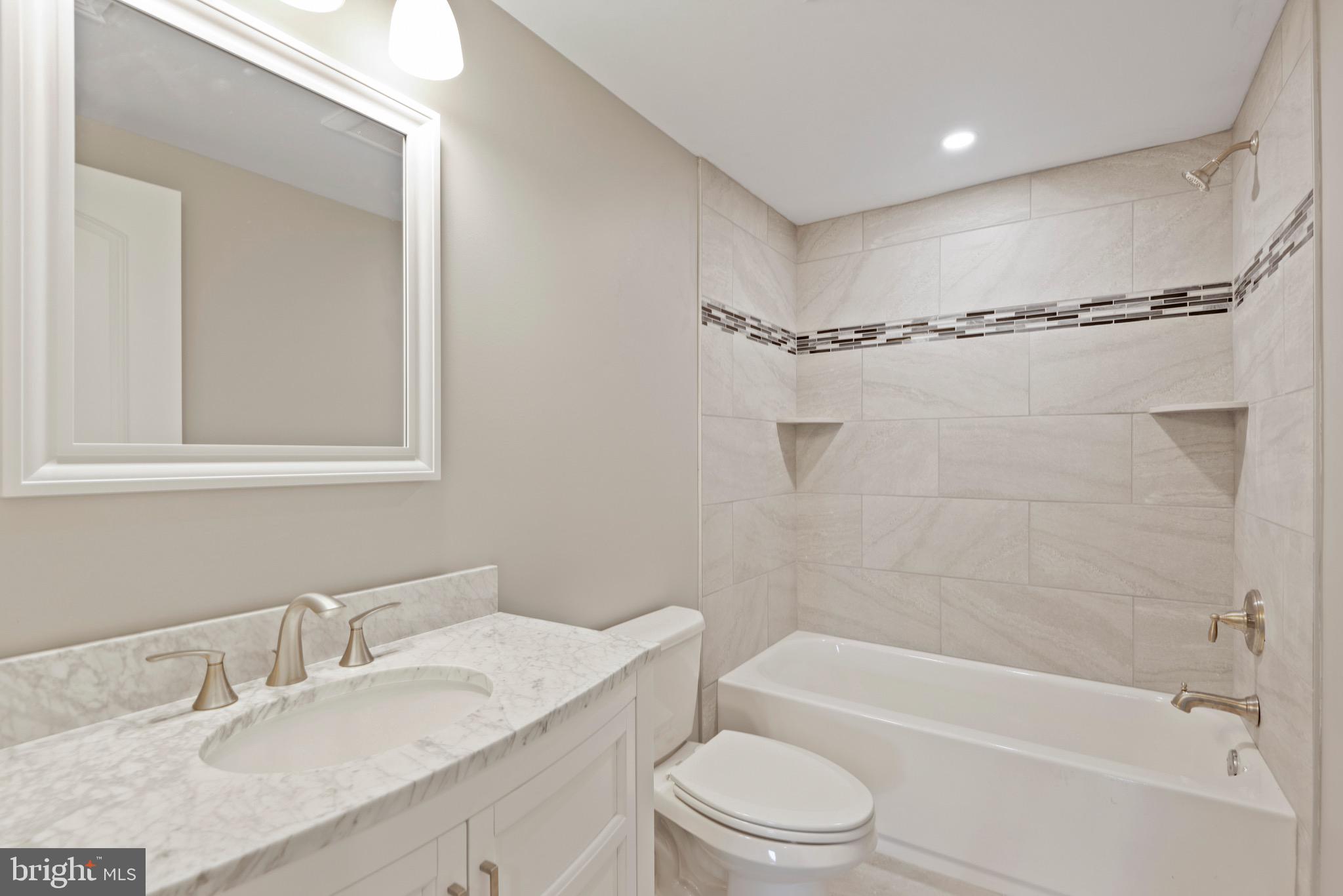 103 East Rose Valley Road Wallingford, PA 19086 - Photo 64 of 75 a bathroom with a granite countertop bathtub shower sink vanity and toilet