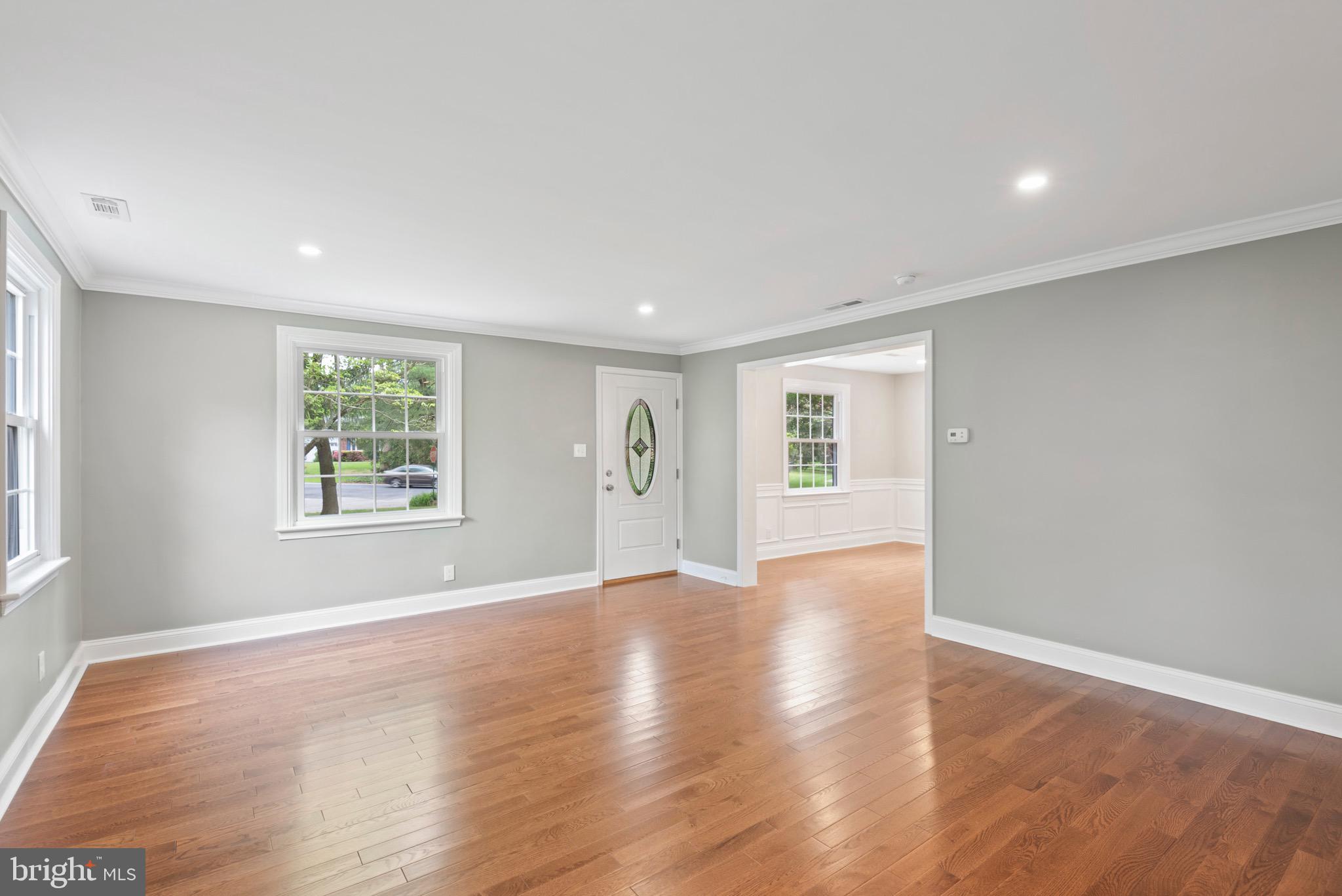 103 East Rose Valley Road Wallingford, PA 19086 - Photo 10 of 75 an empty room with wooden floor and windows