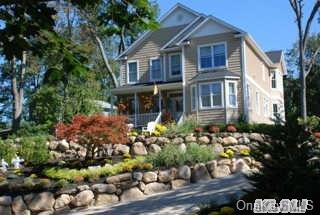 34 Sound Road Wading River, NY 11792 - Photo 1 of 1 front view of a house with a flower garden